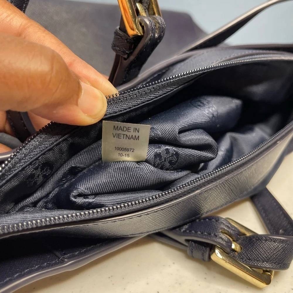Tory Burch Saffiano leather medium Navy Blue top zip tote with material inside.